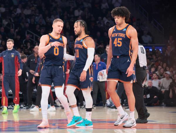 Knicks guard Do<em></em>nte DiVincenzo #0 speaks with New York Knicks guard Jalen Brunson #11 on the court