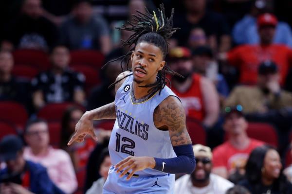 Memphis Grizzlies guard Ja Morant reacts after sinking a three point shot against the Houston Rockets during the first half of an NBA basketball game Wednesday, March 1, 2023, in Houston.