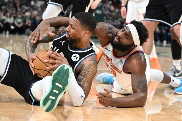 Mitchell Robinson battles with Damian Lillard for possession during the Knicks' win against the Bucks on Sunday.