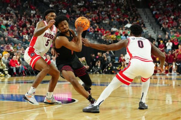 Southern California Trojans guard Bro<em></em>nny James driving the basketball lane amidst Arizona Wildcats guards during a Pac-12 Co<em></em>nference tournament game