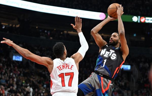 Nets guard Mikal Bridges (1) shoots the ball over Toro<em></em>nto Raptors guard Garrett Temple (17) in the first half at Scotiabank Arena on Monday