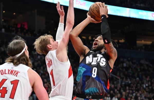 Brooklyn Nets forward Trendon Watfor<em></em>d (9) shoots the ball as Toro<em></em>nto Raptors guard Gradey Dick (1) defends in the first half on Monday.