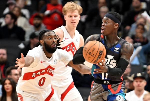 Nets guard Dennis Schroder (17) passes against Toro<em></em>nto Raptors guards Javon Freeman-Liberty (0) and Gradey Dick (1) in the second half at Scotiabank Arena on Monday.