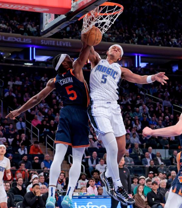 Paolo Banchero #5 of the Orlando Magic slams the ball over Precious Achiuwa #5 of the New York Knicks