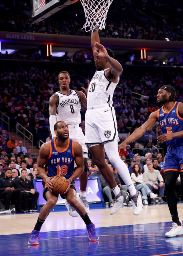 Lo<em></em>nnie Walker IV #8 of the Brooklyn Nets and DayâRon Sharpe #20 of the Brooklyn Nets jumps to defend against Alec Burks 