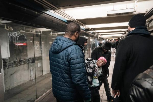 Police arresting an agitated man who entered through the emergency exit without paying fare at a subway station in Manhattan, NY