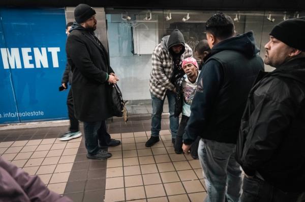 Police officers arresting a man at a Manhattan subway station who entered through emergency exit without paying fare