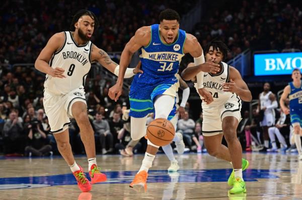 Giannis Antetokounmpo, who scored 21 points, drives up the court as Trendon Wadfor<em></em>d (left) and Cam Thomas defend during the Nets' 115-108 loss to the Bucks.