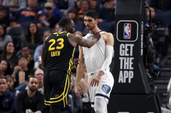 Draymond Green #23 of the Golden State Warriors pulls the jersey of Santi Aldama #7 of the Memphis Grizzlies in the first half at Chase Center on March 20, 2024 in San Francisco, California.