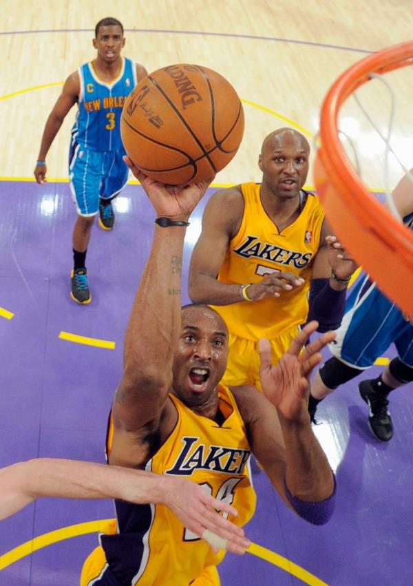 Los Angeles Lakers guard Kobe Bryant, (below) puts up a shot as New Orleans Hornets guard Chris Paul, rear, and Lakers forward Lamar Odom look on during Game 2 of a first-round NBA basketball playoff series April 20, 2011, in Los Angeles. 