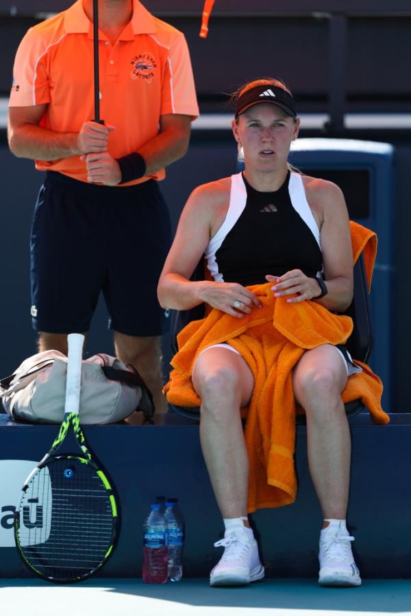 Caroline Wozniacki of Denmark sitting on a bench with a towel on her lap during her women's singles match at the Miami Open.