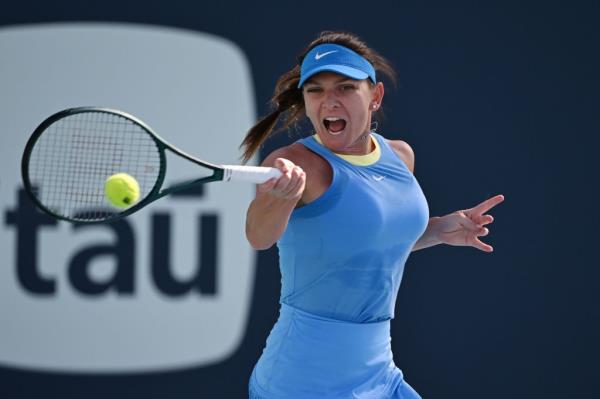 Simona Halep playing tennis at the Miami Open, hitting the ball with her racket.