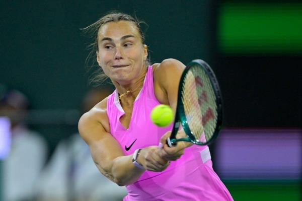 Aryna Sabalenka hits a tennis ball with a racket during her match against Peyton Stearns at the BNP Paribas Open in Indian Wells.