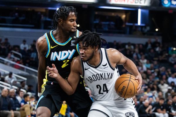  Nets guard Cam Thomas (24) dribbles the ball while Indiana Pacers forward Aaron Nesmith (23) defends