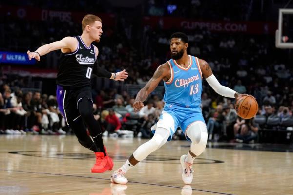 Paul George defended by Do<em></em>nte DiVincenzo in a basketball game between the Los Angeles Clippers and Sacramento Kings in 2022.