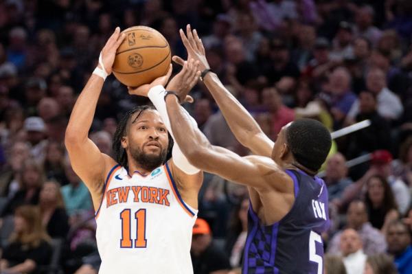 Jalen Brunson (11) shoots the basketball against Sacramento Kings guard De'Aaron Fox (5) during the second quarter at Golden 1 Center.