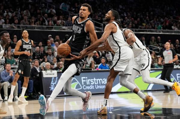 Anto<em></em>nio Spurs forward Victor Wembanyama (1) drives to the basket while defended by Brooklyn Nets forward Mikal Bridges (1) during the first half at Moody Center.